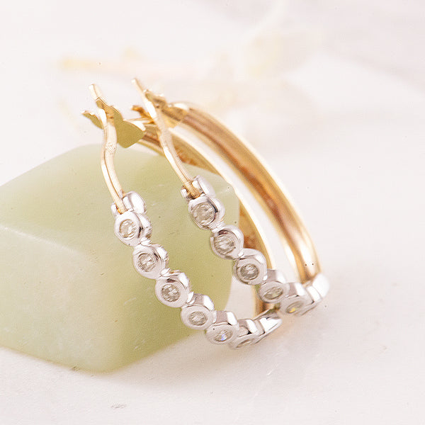 Yellow and White Gold Hoop Earrings Featuring Bezel set Diamonds