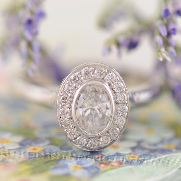 Oval Diamond Bezel Set Halo Ring in White Gold